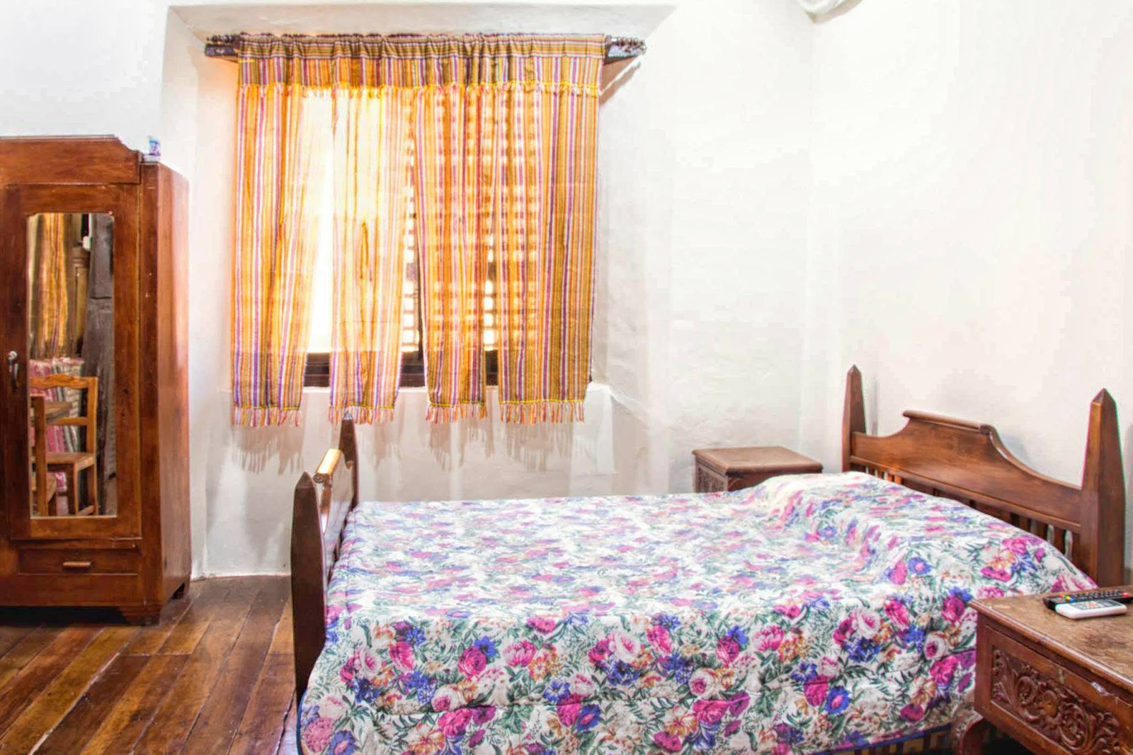 Spacious Family Room 2 with multiple comfortable beds, wooden ceiling beams, and bright heritage atmosphere at Casa de Gabriela