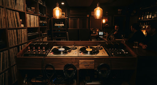 Dual Technics turntables and glowing tube amplifiers in the listening room.