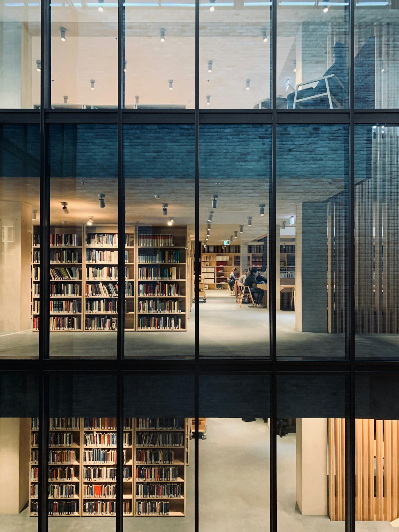 Glass facade of the Meridian Academy building with the reading room visible inside