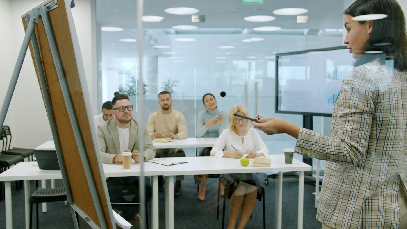 A faculty member presenting to colleagues across an office table